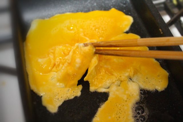 卵を箸でつまむ
