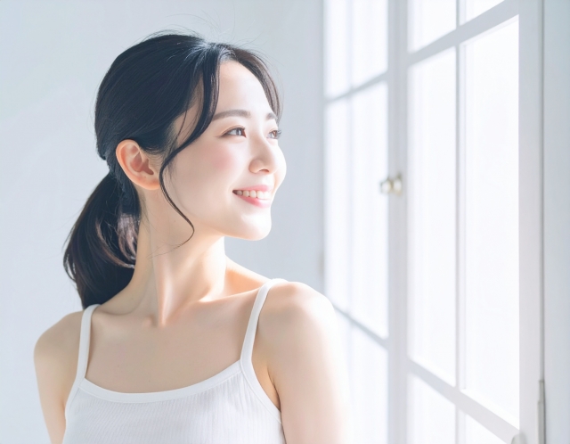 窓際で笑顔の女性