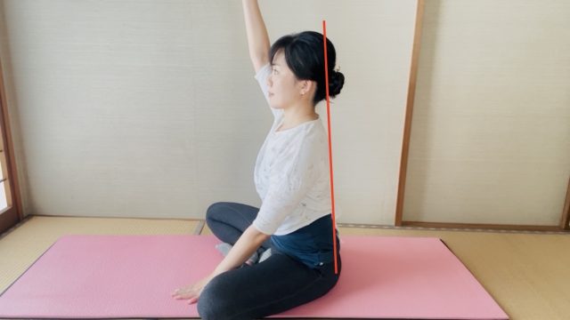 上半身を伸ばして右手をあげた姿勢