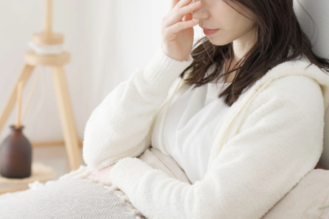 体調不良の女性