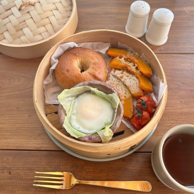 蒸したかぼちゃのチーズがけとベーグル、卵、ミニトマトを盛り合わせた朝ごはん
